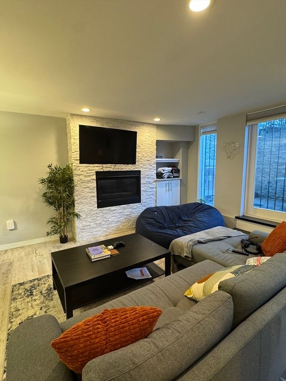 Fireplace, Interior, Living room, Recessed Lighting, Stone Walls, Wood Texture Flooring