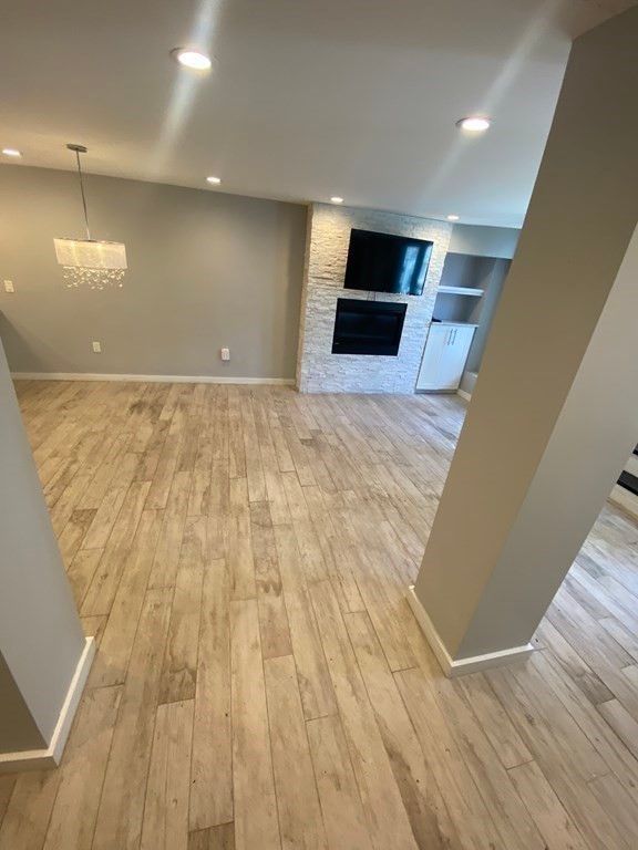 Chandelier, Empty room, Fireplace, Interior, Recessed Lighting, Wood Texture Flooring