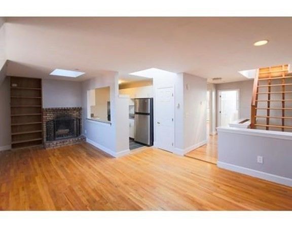 Empty room, Fireplace, Interior, Kitchen, Recessed Lighting, Stainless Steel Appliances, Wood Texture Flooring