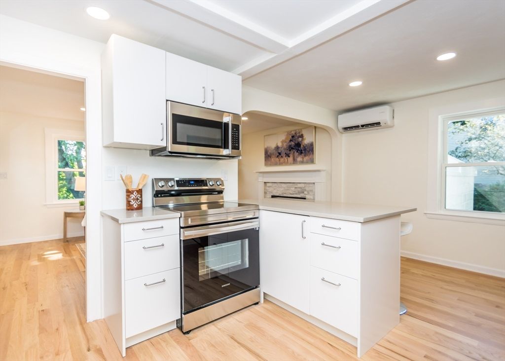 Fireplace, Interior, Kitchen, Recessed Lighting, Stainless Steel Appliances, Wood Texture Flooring