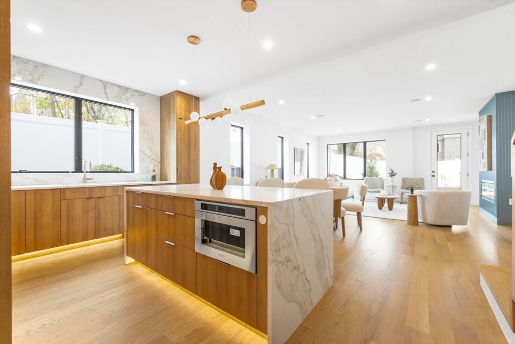 Dining room, Interior, Kitchen, Living room, Marble Walls, Pendant Lights, Recessed Lighting, Stainless Steel Appliances, Wood Texture Flooring