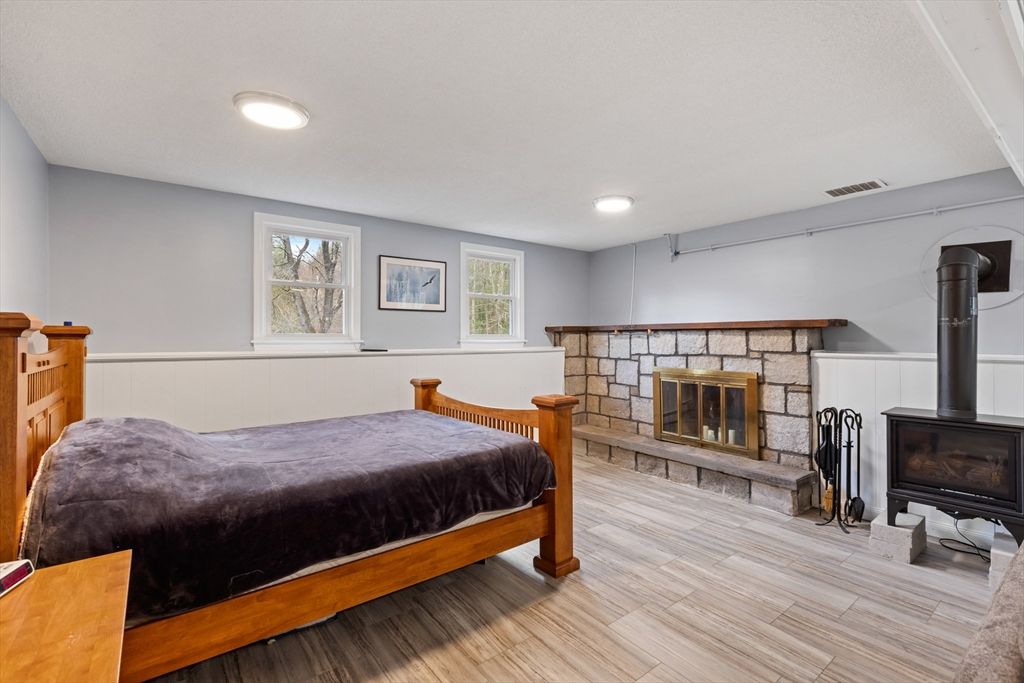 Bedroom, Fireplace, Interior, Recessed Lighting, Stone Walls, Wood Texture Flooring