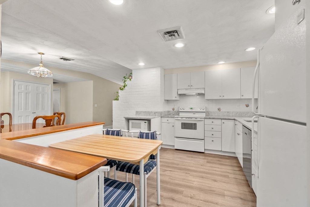 Dining room, Fireplace, Interior, Kitchen, Pendant Lights, Recessed Lighting, Stainless Steel Appliances, Wood Texture Flooring