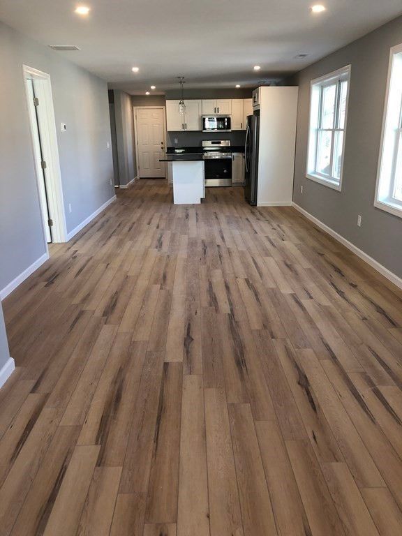 Empty room, Interior, Kitchen, Pendant Lights, Recessed Lighting, Stainless Steel Appliances, Wood Texture Flooring