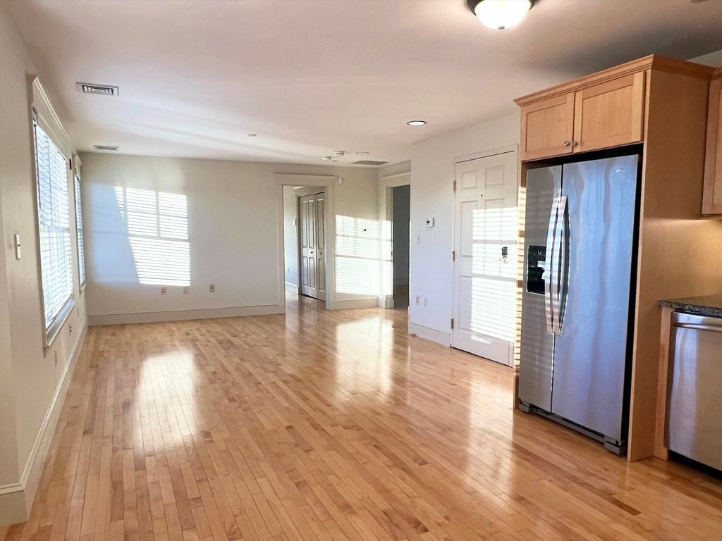 Empty room, Interior, Kitchen, Recessed Lighting, Stainless Steel Appliances, Wood Texture Flooring