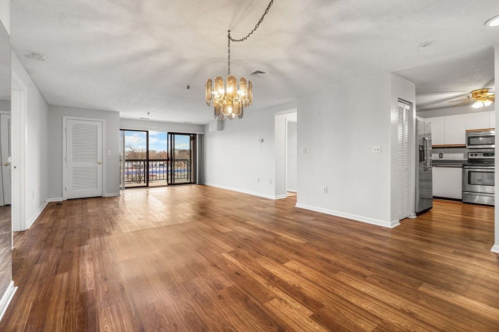 Chandelier, Empty room, Interior, Kitchen, Pendant Lights, Stainless Steel Appliances, Wood Texture Flooring