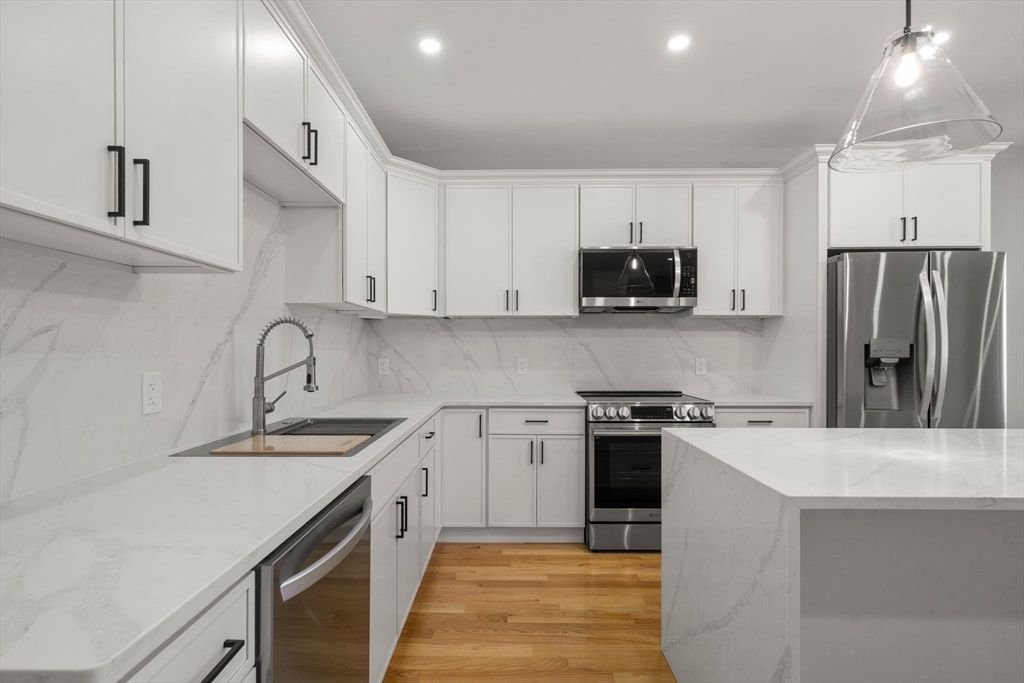 Interior, Kitchen, Marble Walls, Pendant Lights, Recessed Lighting, Stainless Steel Appliances, Wood Texture Flooring