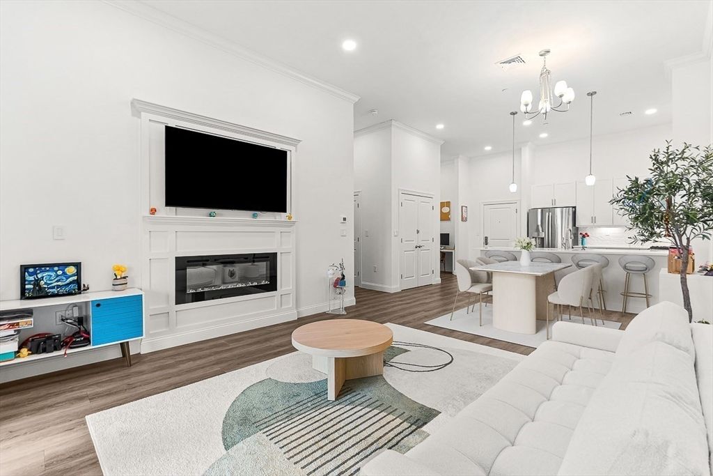 Chandelier, Dining room, Fireplace, Interior, Kitchen, Living room, Pendant Lights, Recessed Lighting, Stainless Steel Appliances, Wood Texture Flooring