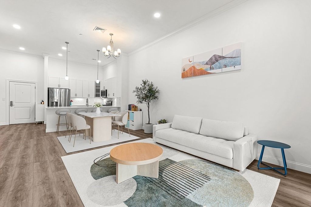 Chandelier, Dining room, Interior, Kitchen, Living room, Pendant Lights, Recessed Lighting, Stainless Steel Appliances, Wood Texture Flooring