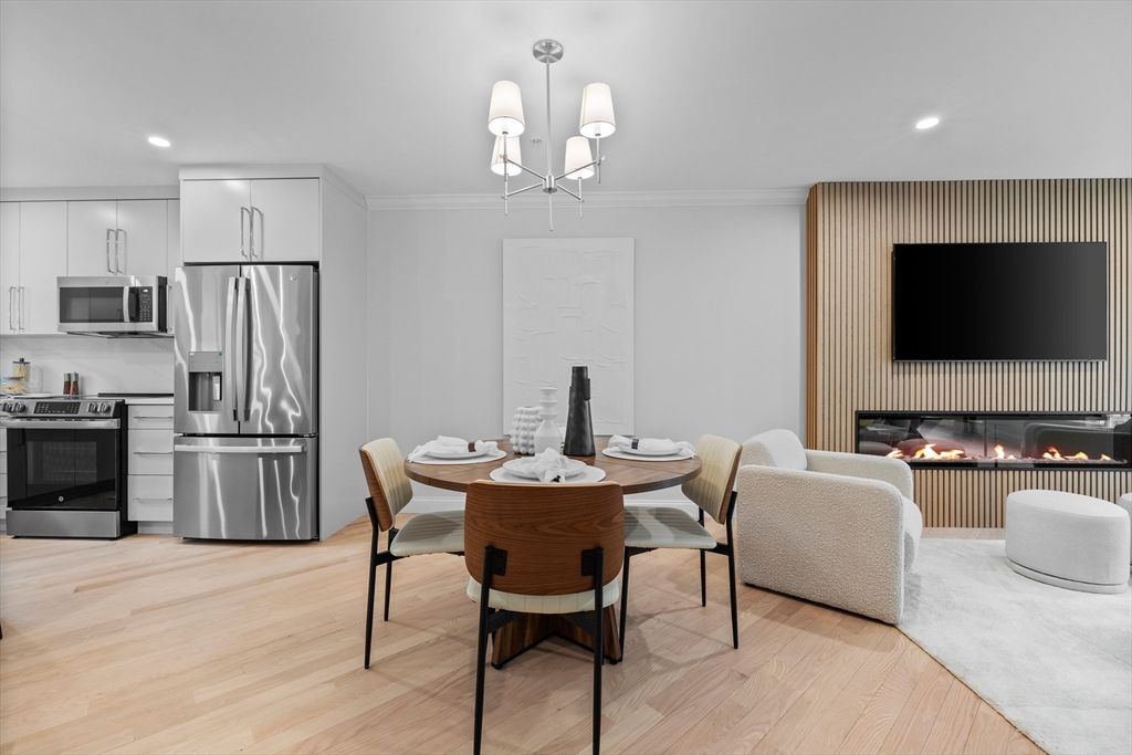 Chandelier, Dining room, Fireplace, Interior, Kitchen, Living room, Recessed Lighting, Stainless Steel Appliances, Wood Texture Flooring