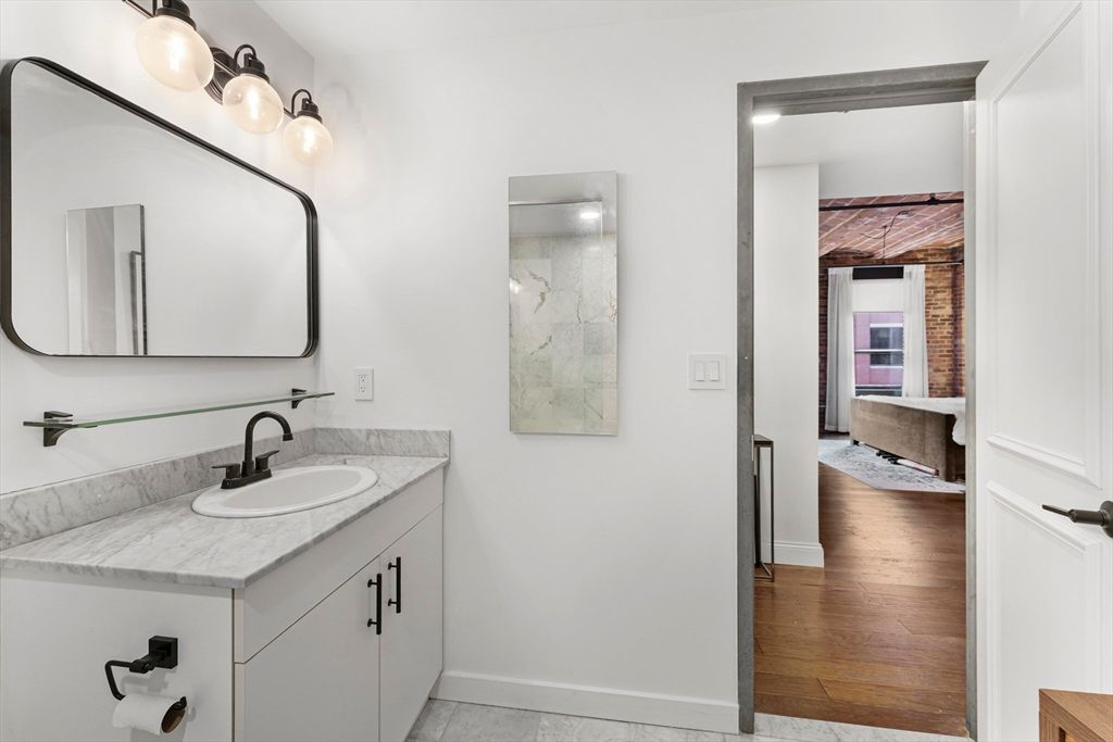 Bathroom, Dual Sink Vanities, Interior, Marble Walls, Wood Texture Flooring