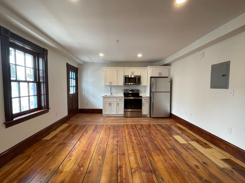 Empty room, Interior, Kitchen, Recessed Lighting, Stainless Steel Appliances, Wood Texture Flooring