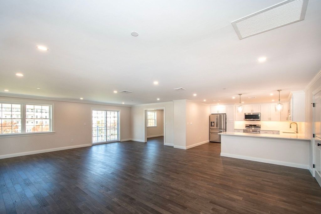 Empty room, Interior, Kitchen, Pendant Lights, Recessed Lighting, Stainless Steel Appliances, Wood Texture Flooring