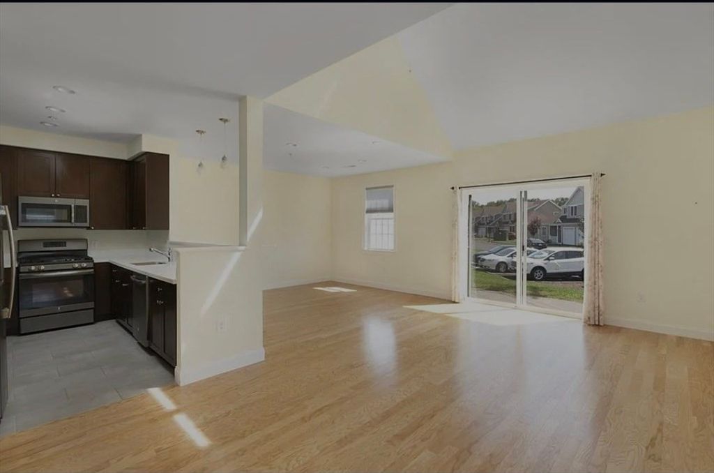 Empty room, Interior, Kitchen, Recessed Lighting, Stainless Steel Appliances, Wood Texture Flooring