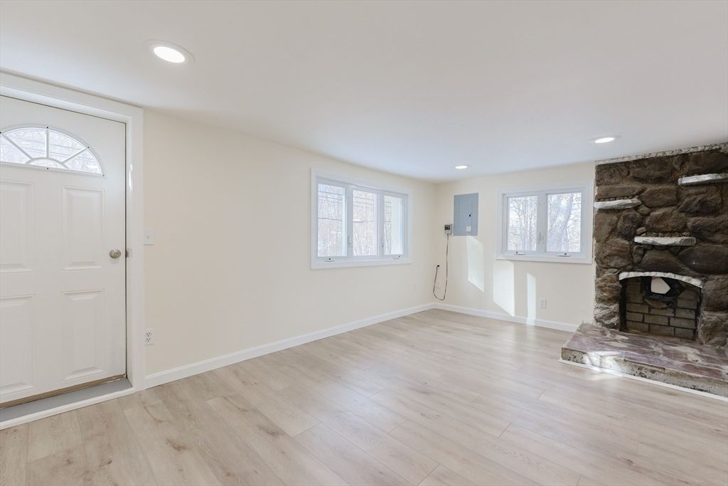 Empty room, Fireplace, Interior, Recessed Lighting, Stone Walls, Wood Texture Flooring