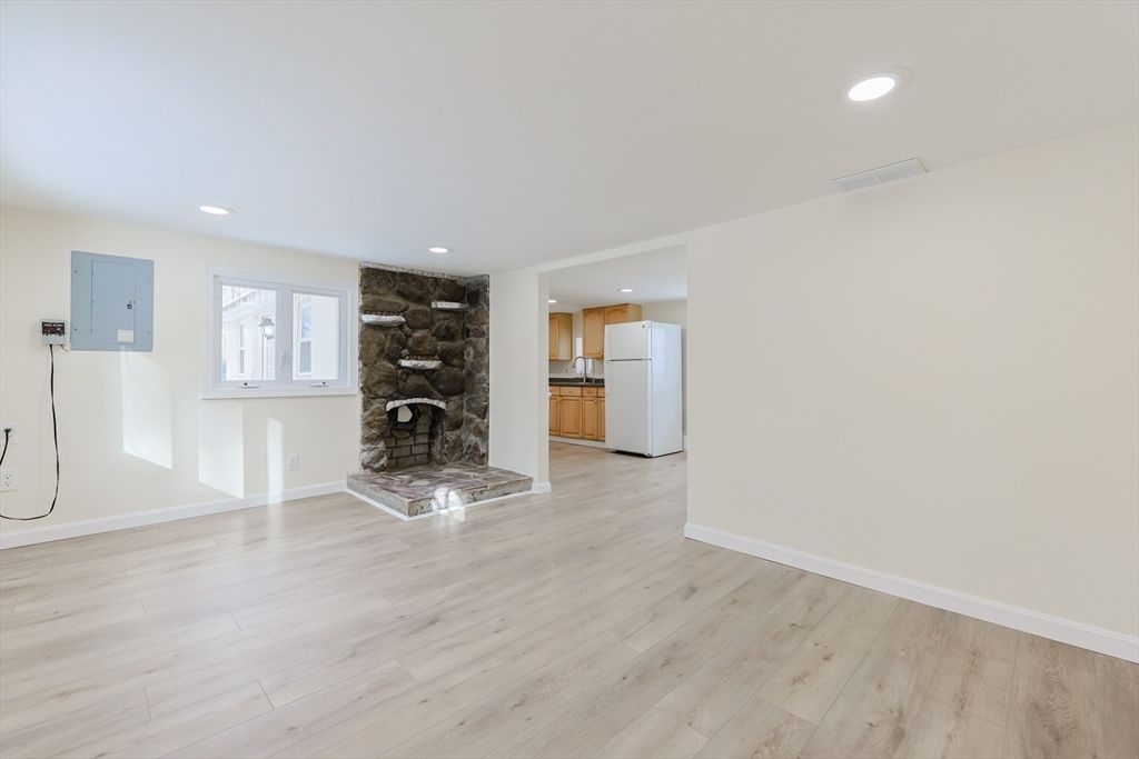 Empty room, Fireplace, Interior, Kitchen, Recessed Lighting, Stone Walls, Wood Texture Flooring