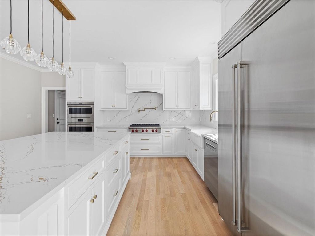 Interior, Kitchen, Marble Walls, Pendant Lights, Recessed Lighting, Stainless Steel Appliances, Wood Texture Flooring