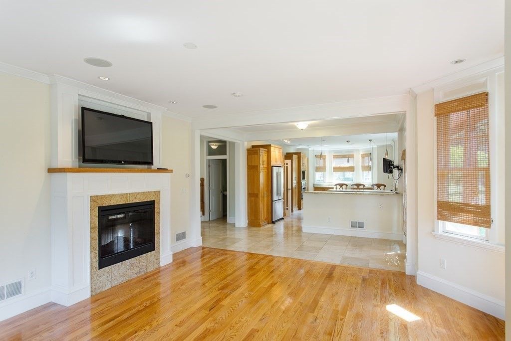 Empty room, Fireplace, Interior, Kitchen, Recessed Lighting, Stainless Steel Appliances, Wood Texture Flooring