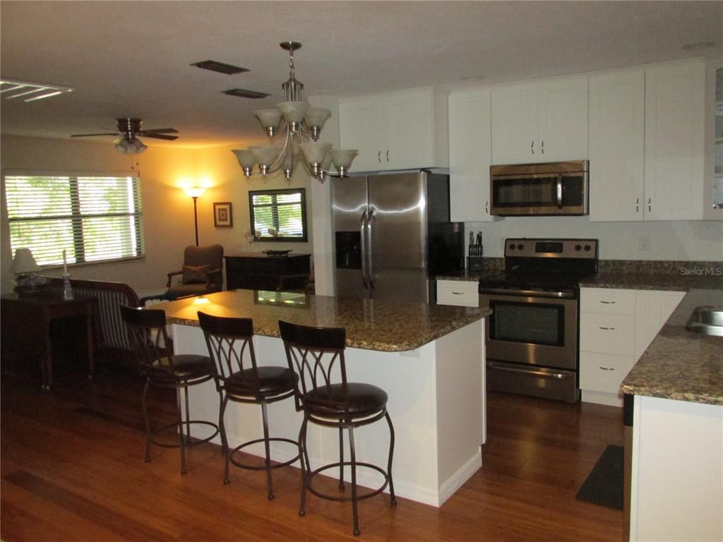 Chandelier, Dining room, Interior, Kitchen, Stainless Steel Appliances, Wood Texture Flooring