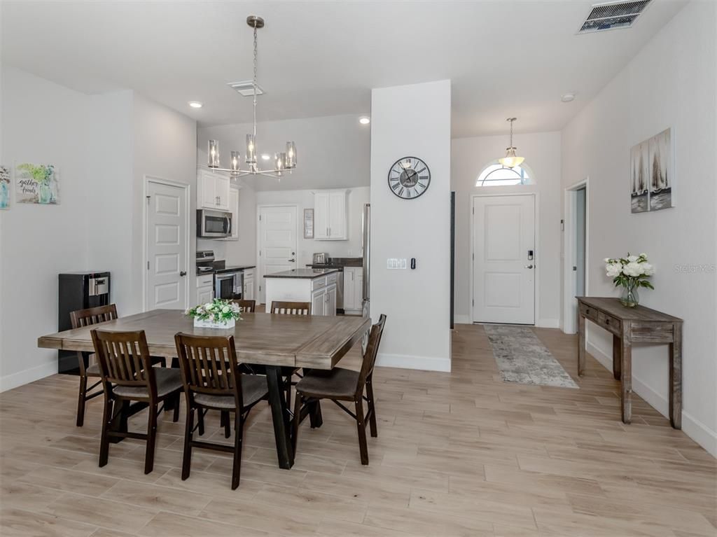 Chandelier, Dining room, Interior, Kitchen, Pendant Lights, Recessed Lighting, Stainless Steel Appliances, Wood Texture Flooring