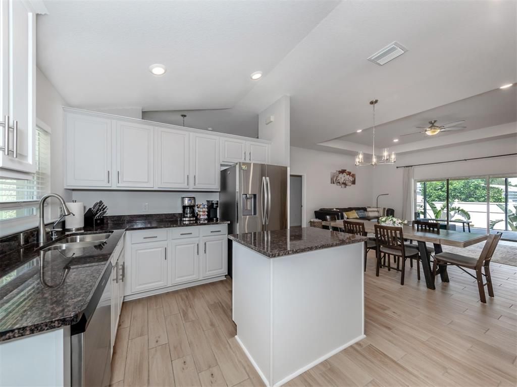 Dining room, Interior, Kitchen, Pendant Lights, Recessed Lighting, Stainless Steel Appliances, Wood Texture Flooring