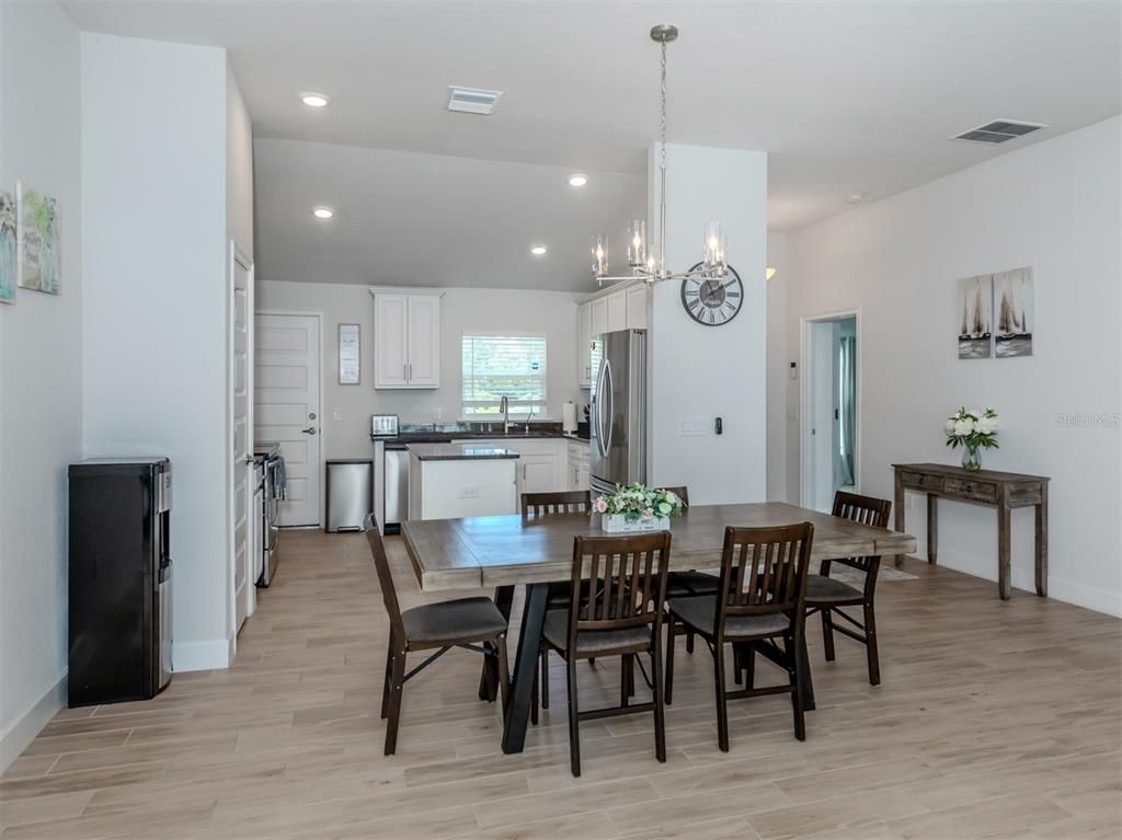 Chandelier, Dining room, Interior, Kitchen, Recessed Lighting, Stainless Steel Appliances, Wood Texture Flooring