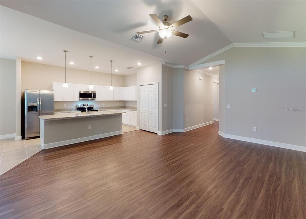 Empty room, Interior, Kitchen, Pendant Lights, Recessed Lighting, Stainless Steel Appliances, Wood Texture Flooring