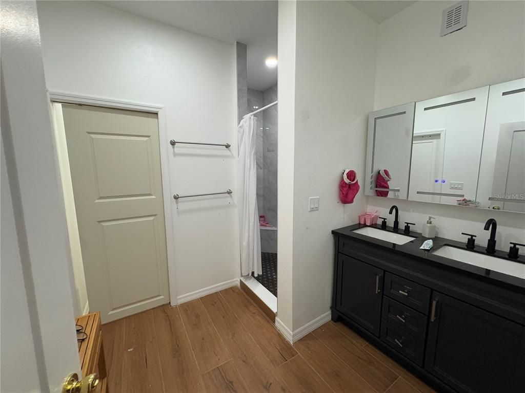 Bathroom, Dual Sink Vanities, Interior, Recessed Lighting, Wood Texture Flooring