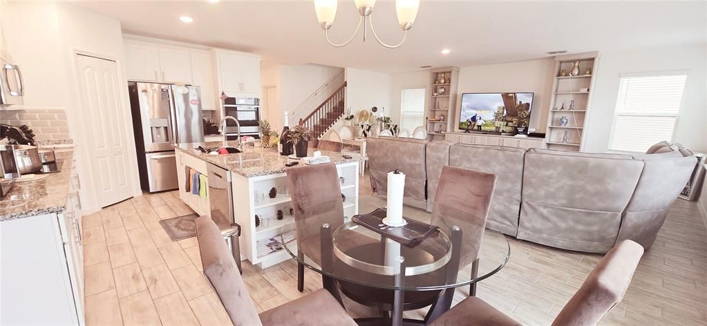 Chandelier, Dining room, Interior, Kitchen, Living room, Recessed Lighting, Stainless Steel Appliances, Wood Texture Flooring