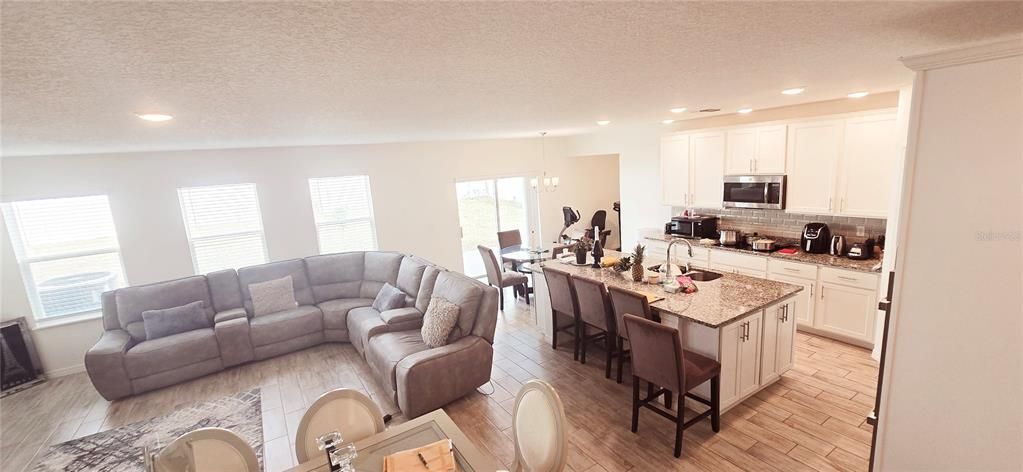 Dining room, Interior, Kitchen, Living room, Pendant Lights, Recessed Lighting, Stainless Steel Appliances, Wood Texture Flooring