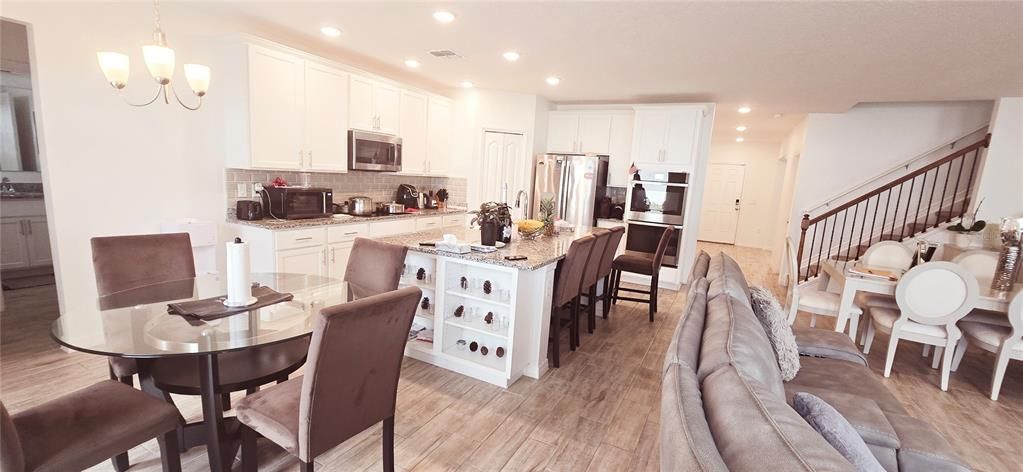 Chandelier, Dining room, Interior, Kitchen, Pendant Lights, Recessed Lighting, Stainless Steel Appliances, Wood Texture Flooring