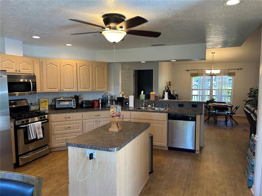 Dining room, Interior, Kitchen, Pendant Lights, Recessed Lighting, Stainless Steel Appliances, Wood Texture Flooring