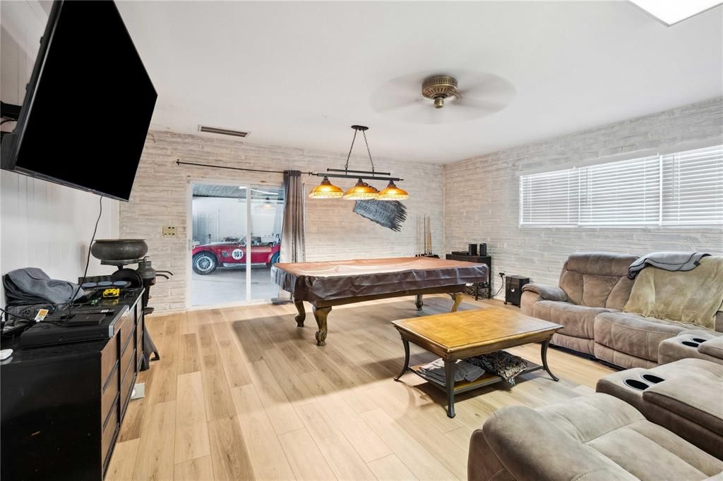 Billiard Table, Chandelier, Game Room, Interior, Living room, Pendant Lights, Stone Walls, Wood Texture Flooring