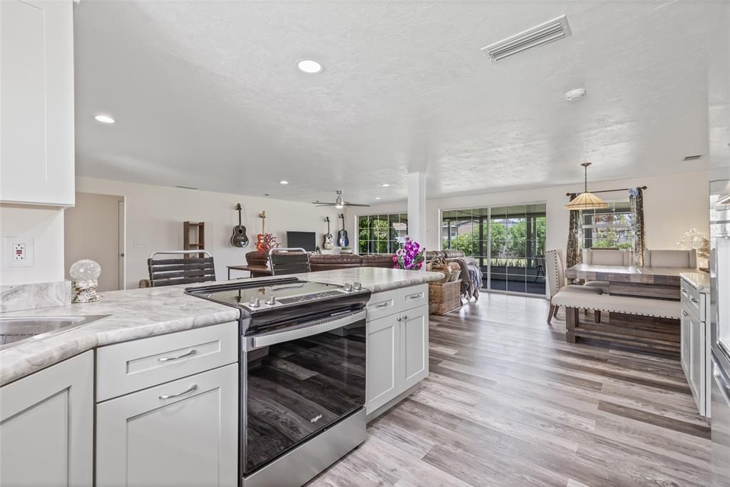 Dining room, Interior, Kitchen, Living room, Pendant Lights, Recessed Lighting, Stainless Steel Appliances, Wood Texture Flooring