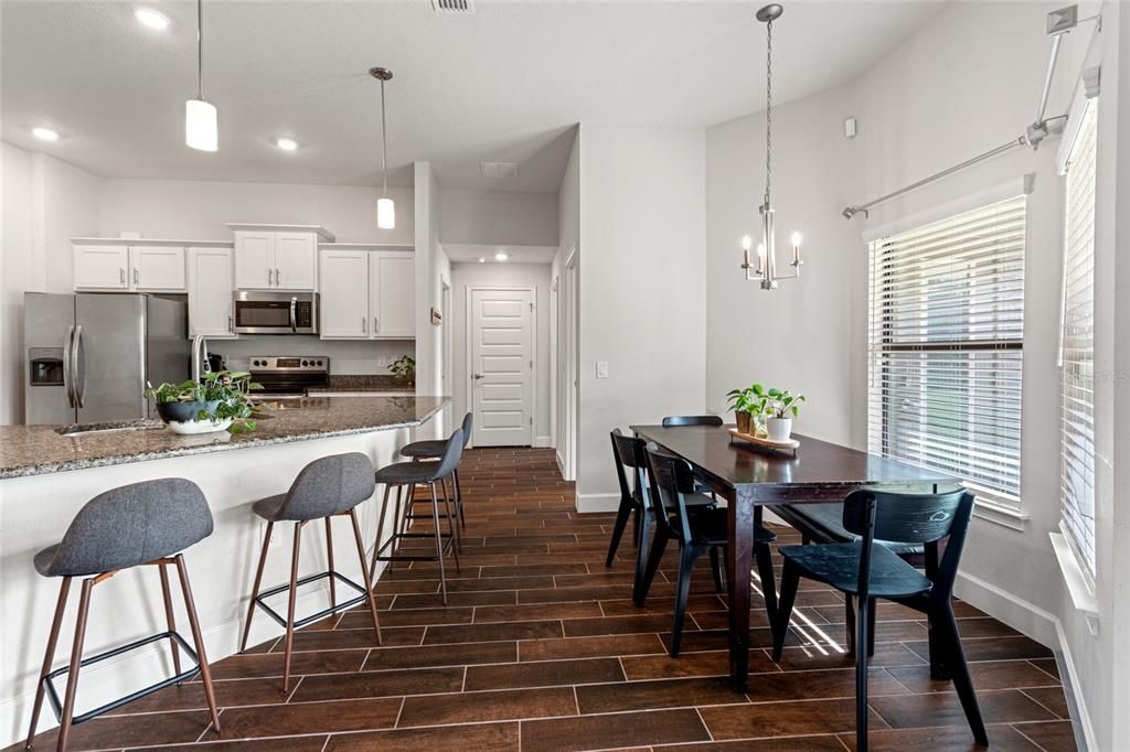 Dining room, Interior, Kitchen, Pendant Lights, Recessed Lighting, Stainless Steel Appliances, Wood Texture Flooring