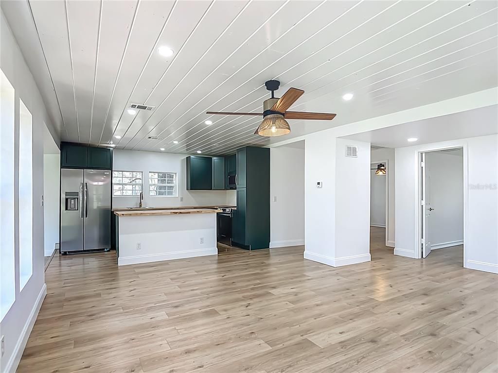 Empty room, Interior, Kitchen, Recessed Lighting, Stainless Steel Appliances, Wood Texture Flooring