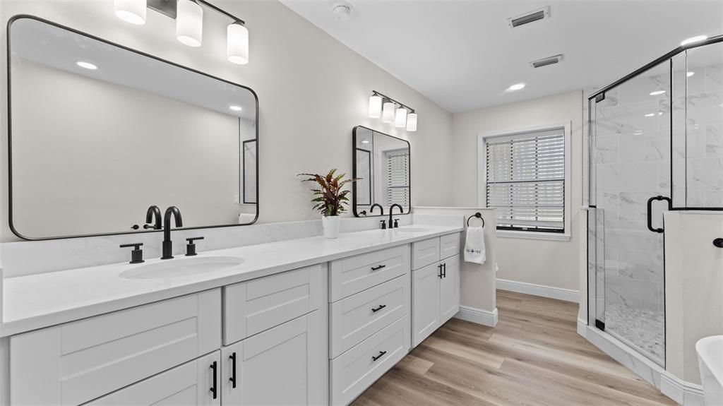 Bathroom, Dual Sink Vanities, Glass Shower, Interior, Marble Walls, Recessed Lighting, Wood Texture Flooring