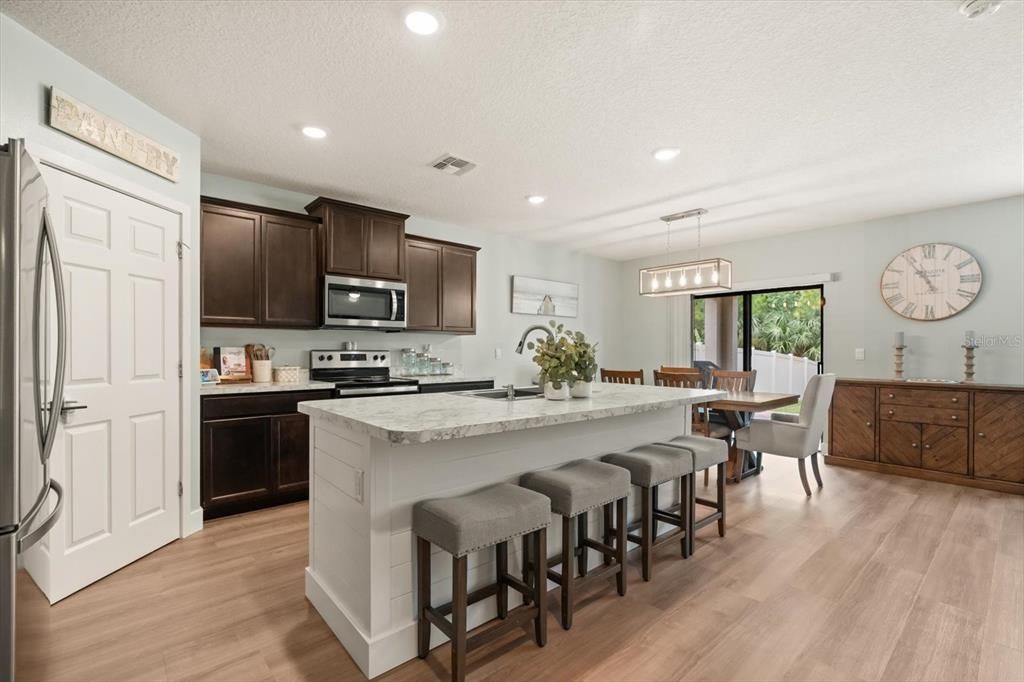 Dining room, Interior, Kitchen, Pendant Lights, Recessed Lighting, Stainless Steel Appliances, Wood Texture Flooring