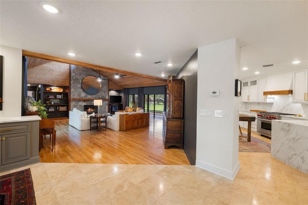 Dining room, Fireplace, Interior, Kitchen, Living room, Marble Walls, Recessed Lighting, Stainless Steel Appliances, Wood Texture Flooring