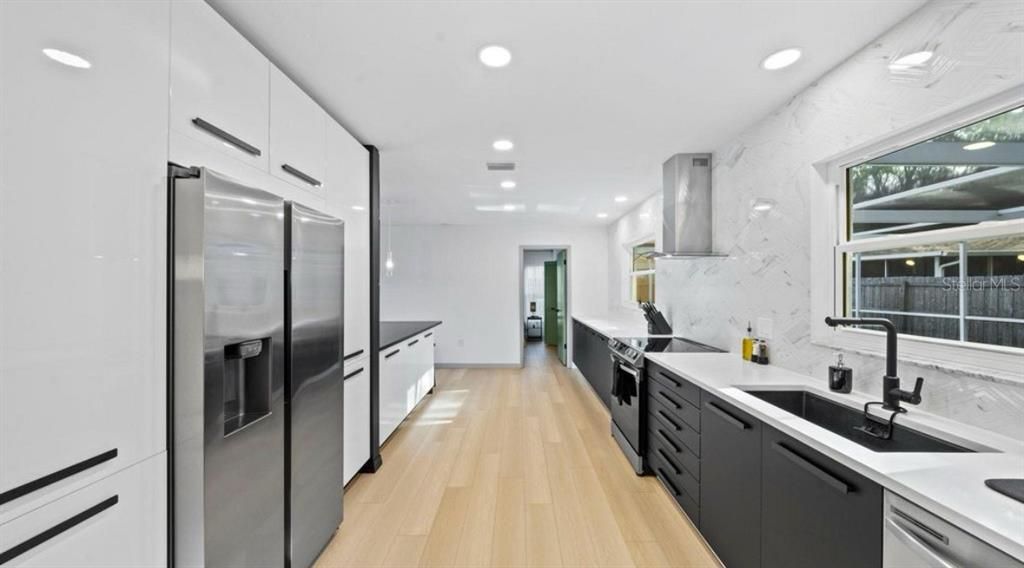 Interior, Kitchen, Marble Walls, Recessed Lighting, Stainless Steel Appliances, Wood Texture Flooring