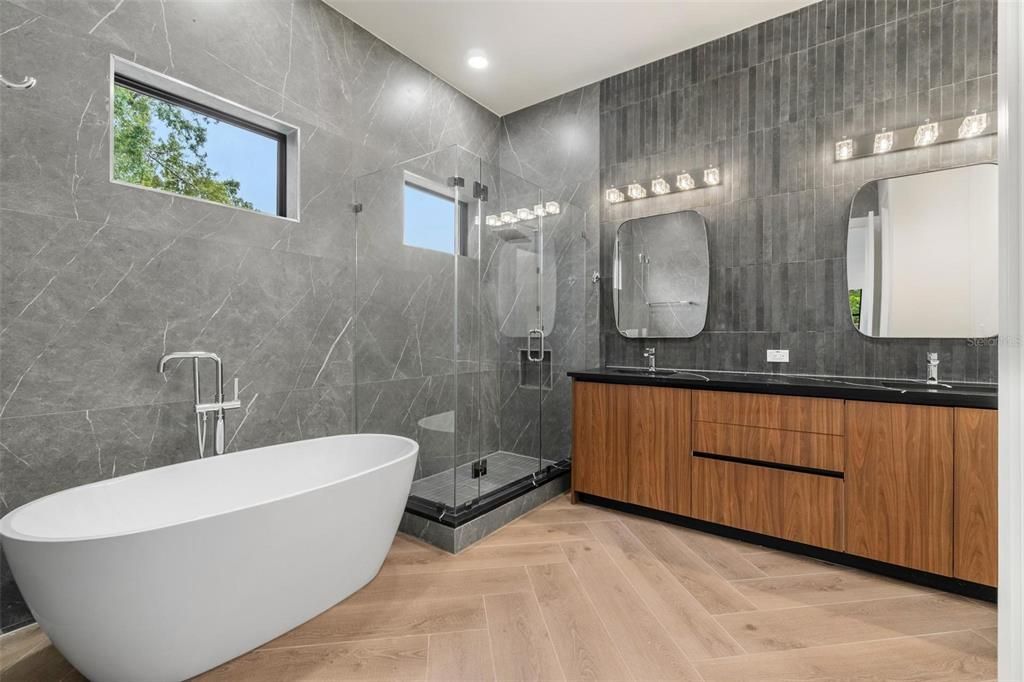 Bathroom, Dual Sink Vanities, Free Standing Baths, Glass Shower, Interior, Marble Walls, Recessed Lighting, Wood Texture Flooring
