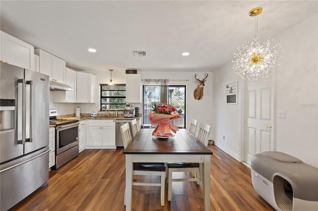 Dining room, Interior, Kitchen, Pendant Lights, Recessed Lighting, Stainless Steel Appliances, Wood Texture Flooring