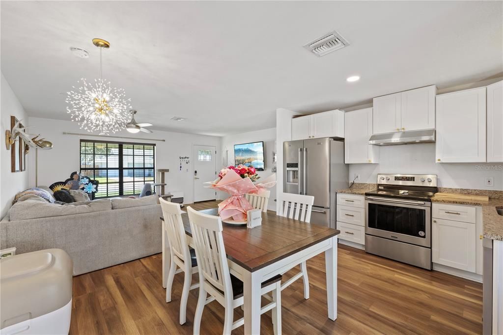 Dining room, Interior, Kitchen, Living room, Pendant Lights, Recessed Lighting, Stainless Steel Appliances, Wood Texture Flooring