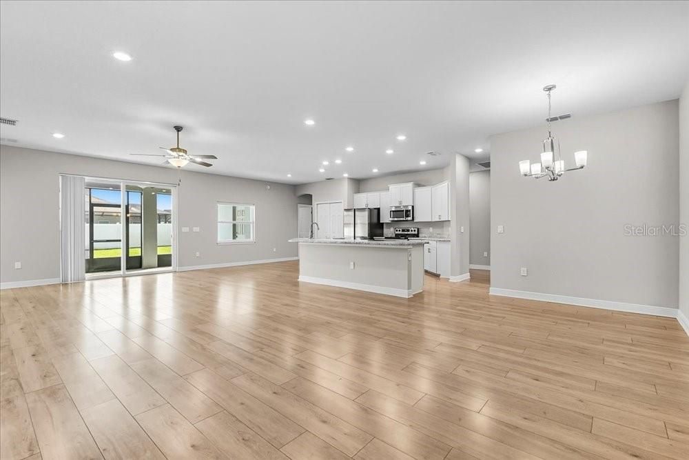 Chandelier, Empty room, Interior, Kitchen, Recessed Lighting, Stainless Steel Appliances, Wood Texture Flooring
