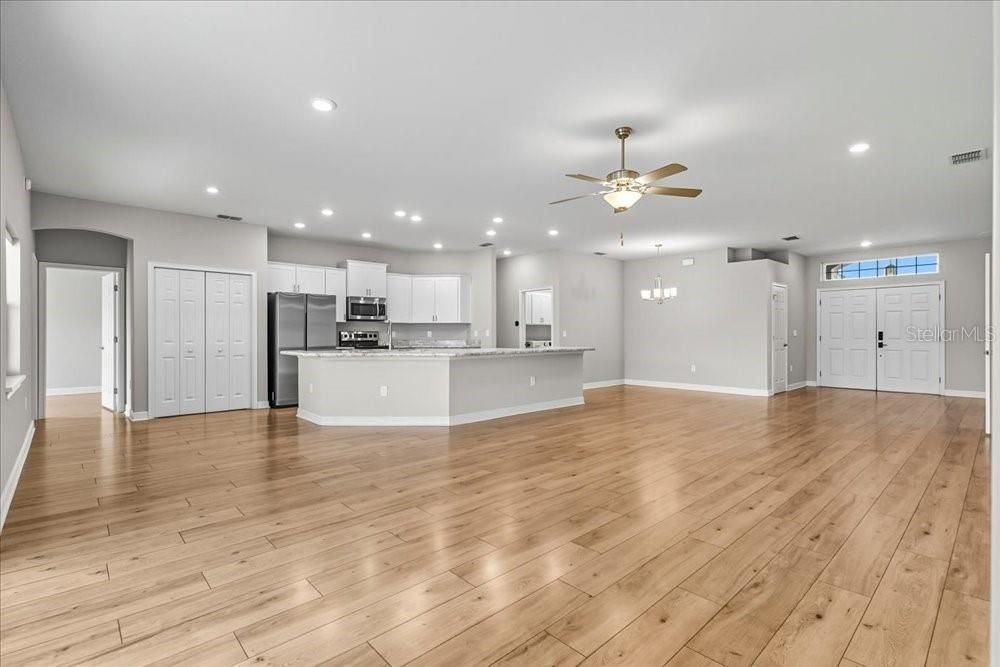 Empty room, Interior, Kitchen, Recessed Lighting, Stainless Steel Appliances, Wood Texture Flooring
