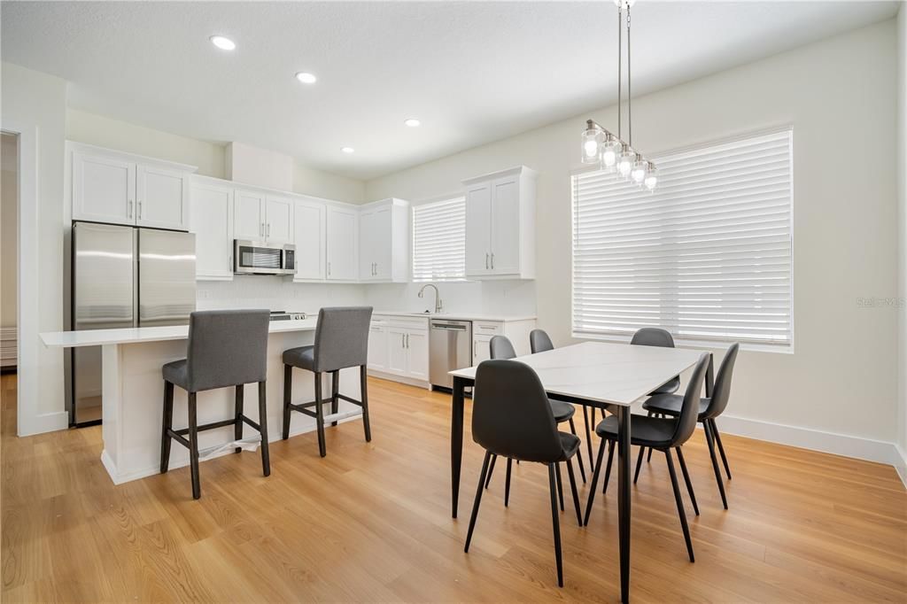 Dining room, Interior, Kitchen, Pendant Lights, Recessed Lighting, Stainless Steel Appliances, Wood Texture Flooring