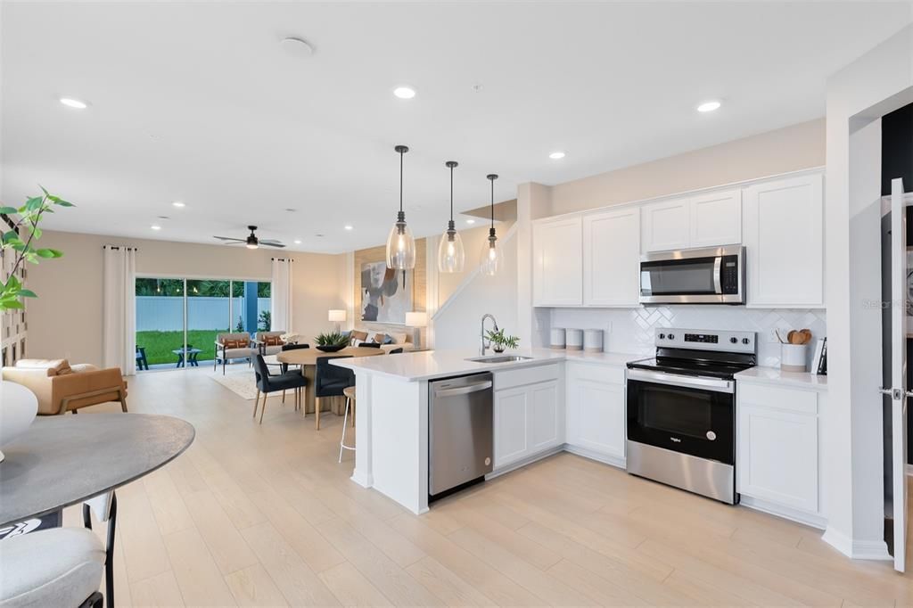 Dining room, Interior, Kitchen, Pendant Lights, Recessed Lighting, Stainless Steel Appliances, Wood Texture Flooring