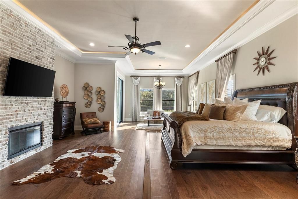 Bedroom, Chandelier, Fireplace, Interior, Recessed Lighting, Stone Walls, Wood Texture Flooring
