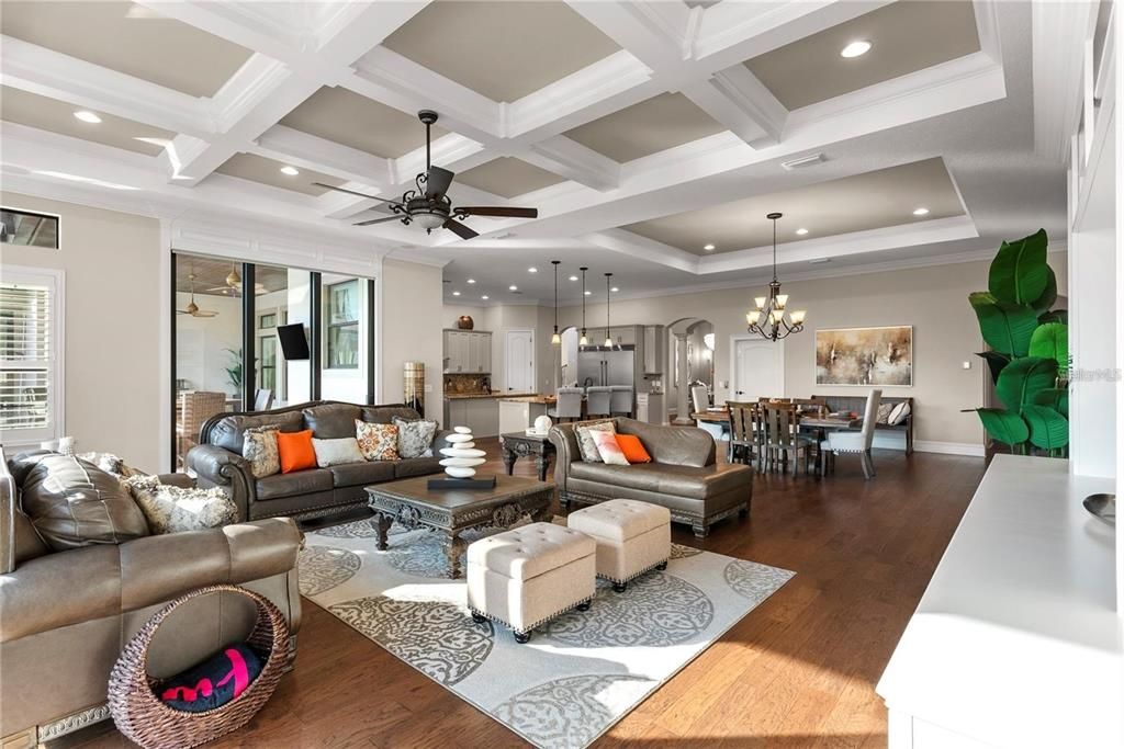 Chandelier, Dining room, Interior, Kitchen, Living room, Pendant Lights, Recessed Lighting, Stainless Steel Appliances, Wood Texture Flooring