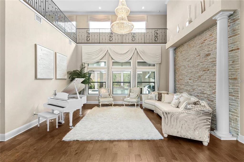 Chandelier, Interior, Living room, Piano, Recessed Lighting, Stone Walls, Wood Texture Flooring